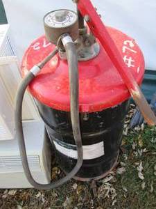 lot 155 image: Metal barrel with #72 fluid pump to...