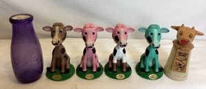 lot 135 image: Collectible Cow Bundle - Vintage Whirley Industries Moo-Cow Creamer, E.K. Mack Creamery Bottle and Kemps Boobleheads