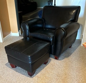 lot 67 image: Bold Black Faux Leather Chair with Ottoman