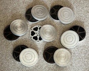 lot 71 image: Seven Fabulous Vintage Bell and Howell Film Reels with Cases