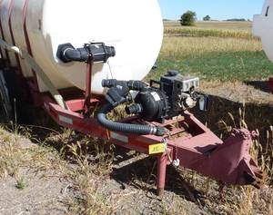 1,000 gallon poly tank on running gear, with pump and motor