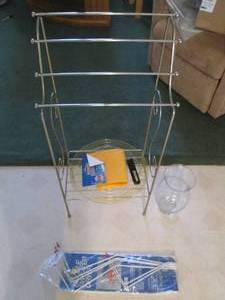 Brass tone freestanding towel rack...
