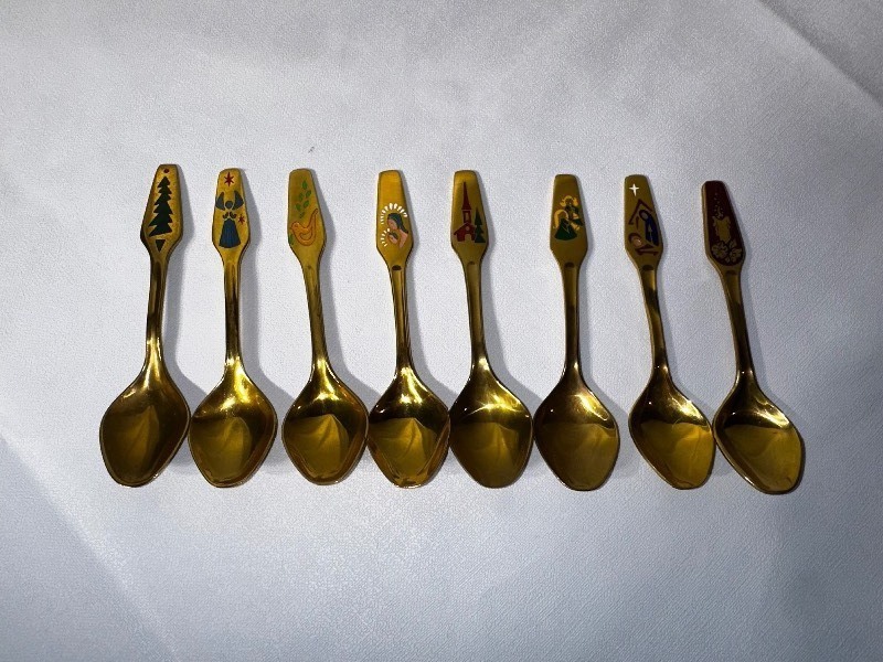 lot 548 image: Vintage MEKA Denmark Gold Plated Holiday Spoon Set of Eight. Years 1966, 1967, 1970,1971, 1972, 1977,1978, & 1983