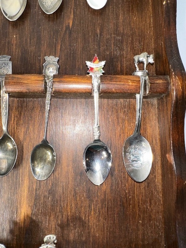 lot 550 image: Variety of Antique and Vintage Silver Plated Souvenir Spoons from Various States in the US and Canada. 16 Total with Spoon Rack