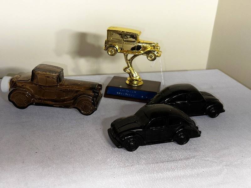 lot 1030 image: Three Vintage Avon Car Cologne Bottles And Car Trophy, Two Empty and One with Cologne