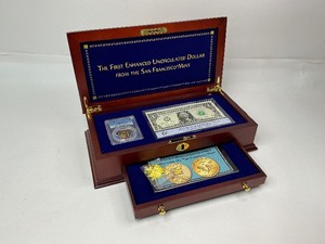 lot 41 image: The First Enhanced Uncirculated Dollar from the San Francisco Mint in a Cherrywood Box.