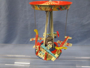 lot 54 image: German Litho Windup Circus Carousel Airplanes