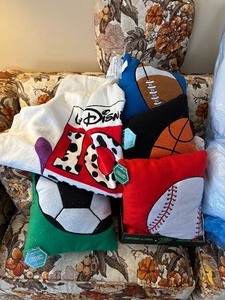 lot 191 image: Sport Themed Throw Pillows and Disney Beach Towel