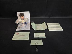 lot 114 image: Marie Osmond Baby Donny Tiny Tot Doll with Certificate of Authenticity and Necklace