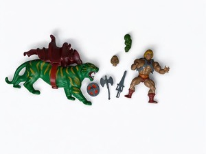 lot 84 image: Vintage He-Man Action Figure Set with Battle Cat, Extra Head, & Accessories - MOTU