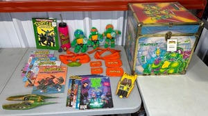 lot 110 image: Teenage Mutant Ninja Turtles Vintage Collection - Magazines, Plush Toys, Costumes, and Storage Chest - Some New with Tags