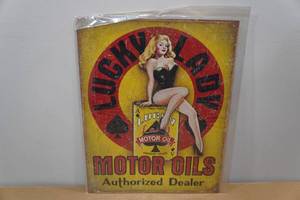 lot 215 image: Metal Lucky Lady Motor Oil Sign