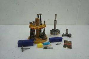 lot 12 image: Assortment of router bits with stand