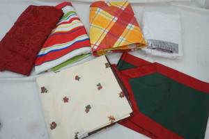 lot 189 image: tablecloth lot white lace 60x84, red plaid round, red stripe, red round 70, leaf square, green table runner