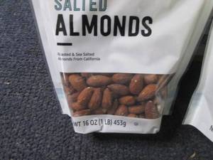 lot 130 image: 2- 16 oz Happy Belly Salted Almonds...