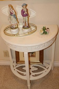 lot 87 image: Victorian Home Decor Accent Half-Moon Flush Wall Table, Framed Print, Oval Brass Dresser Mirror, Figurines