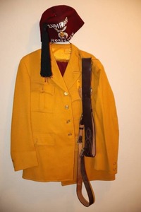 lot 160 image: Vintage Zuhrah Horsemen Shriners Marching Uniform Fez Hat, Wessners Clothiers Tailors Coat & Pants, Flag Belt Leather Strap Etc