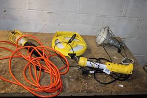 Assorted Electrical Tools and Equipment Work Light, Extension Cord, and Measuring Tape
