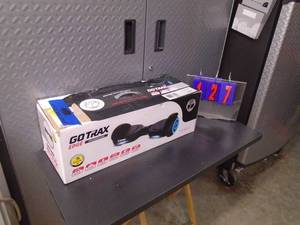 Go Trax edge hover-board Looks new in box with charger. Powers up with error. As shown.
