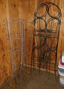 Two Black rod iron trellis, 2 not quite as heavy green iron trellis, 3 tomato cages