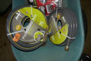 Two new rolls of heavy duty garden hose 50 and 75 ft
