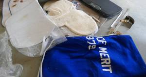 Group of used saddle pads and blanket and comb