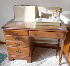 lot 13 image: Desk with glass cover and a Singer sewing machine