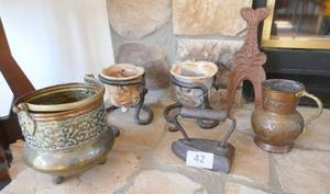 lot 42 image: An interesting group of brass, copper, pottery candle holders with iron feet, and an old sad iron