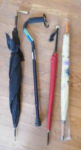 lot 96 image: THREE umbrellas and a adjustable cane