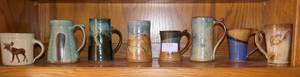 lot 121 image: Group of Eight unique pottery mugs