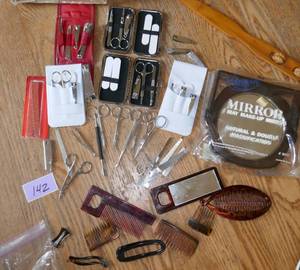 lot 142 image: Large group of finger nail clipper sets, combs, makeup mirror