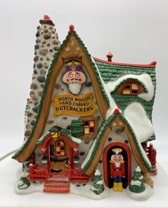 lot 483 image: DEPT 56 North Pole Series, 2001 North Woods Handcarved Nutcracker Factory House