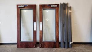 lot 021 image: 60 x 68 Left-Hand Swing Double Solid Core Wood Doors with Glass Kit, Metal Frame, and Hardware
