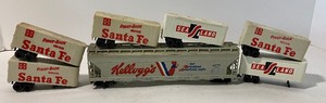 lot 117 image: Vintage Five Piece Model Train Accessory LOT - One Kelloggs Car, Three Santa Fe Piggy Back Trailers, One Sea Land Trailer