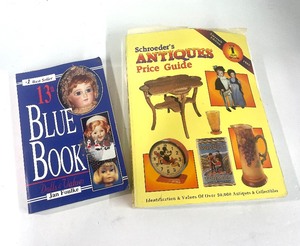 lot 177 image: Book on Collecting Antiques,  Doll Collecting Blue Book and 15 Doll Stands