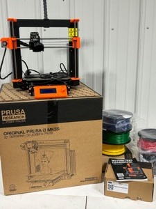lot 37 image: Original PRUSA i3 MK3S 3D Printer (orange) - Like New With Many Spools of PLA Filament