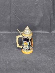 lot 24 image: Vintage Ceramic Beer Stein with Metal Lid & Detailed Coat of Arms Design
