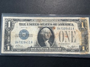 lot 7 image: 1928 Blue Seal $1 Dollar Silver Certificate Funnyback