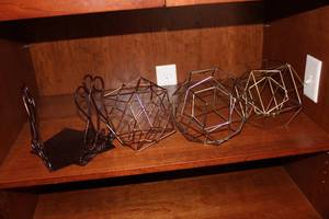 lot 27 image: Set of 4 Geometric Wire Decor Pieces with Black Stand