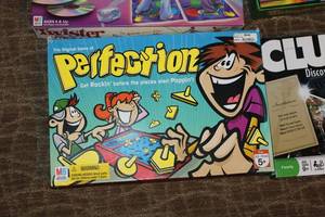 lot 232 image: Assorted Board Games Including Clue, Twister Moves, and Perfection