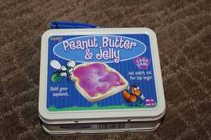 lot 233 image: Lot of 4 Fun Games Peanut Butter & Jelly Card Game, Clue Jr., Find It Game, KNex Building Set