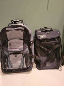 lot 104 image: Two wheeled Travel  Bags by High Sierra and Travelpro.