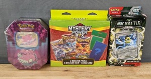 lot 36 image: Brand New Pokmon Trading Card Game Blissey Tin Box, Pokmon Mystery Power Box and Melmetal Ex Pokmon Ex Battle Deck N