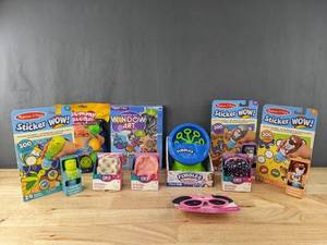 lot 616 image: Brand New Collection of 10 Kids Toys Melissa & Doug Sticker Wow Books, Mini Backpack with Stationary, Fubbles Bubble Machine, Minnie Sungalsses and More W
