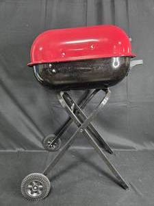 lot 22 image: Portable Charcoal Grill with Red Lid and Black Base