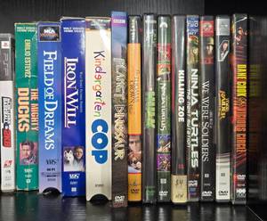lot 148 image: Lot of Vintage Movies on VHS and DVD including Field of Dreams, Kindergarten Cop, and Ninja Turtles
