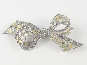 lot 8 image: Marcel Boucher Vintage (C 1940S) Ribbon Bow With Rhinestones And Cream And Pale Green Enameled Leaves. White Base Metal Brooch.