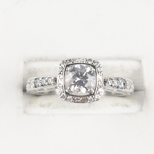 lot 55 image: Stuller Round Cut CZ With Halo Intricate Silver Tone Base Metal Engagement Style Ring. Size 6.75 - 7.