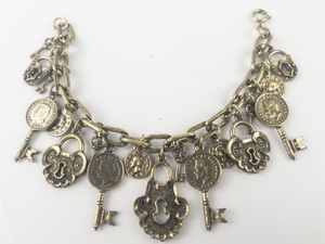 lot 212 image: Antiqued Lock & Coin Key Gold Tone Base Metal Charm Bracelet.