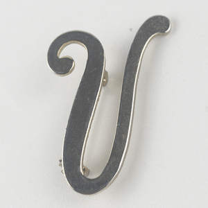 lot 231 image: V Letter Brass Brooch .
